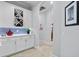 Hallway featuring white cabinetry with wine rack, blue backsplash and recessed lighting at 11447 Savannah Lakes Dr, Parrish, FL 34219