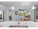 Kitchen with an island, stainless appliances, and natural light from adjacent dining and pool area at 11447 Savannah Lakes Dr, Parrish, FL 34219