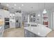 Bright modern kitchen with stainless appliances, white countertops and ample cabinet storage at 11447 Savannah Lakes Dr, Parrish, FL 34219