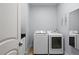 Convenient laundry room with modern washer and dryer units and clean, neutral tones at 11447 Savannah Lakes Dr, Parrish, FL 34219