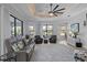 Spacious living room with ceiling fan, leather sofas, and sliding door to the outdoors at 11447 Savannah Lakes Dr, Parrish, FL 34219