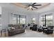 Open living room with ceiling fan, leather sofa, and views of the lanai at 11447 Savannah Lakes Dr, Parrish, FL 34219