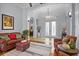 Open-concept living room featuring a comfortable seating arrangement, hardwood floors, and stylish decor at 11447 Savannah Lakes Dr, Parrish, FL 34219