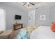 Main bedroom with ceiling fan, sitting area, and console table at 11447 Savannah Lakes Dr, Parrish, FL 34219