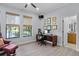 Beautiful office with wood-look tile flooring, natural light, and adjacent bathroom at 11447 Savannah Lakes Dr, Parrish, FL 34219