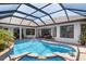 The backyard pool offers a relaxing atmosphere and is framed by windows into the house at 11447 Savannah Lakes Dr, Parrish, FL 34219
