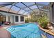 Refreshing pool with screened enclosure and landscaped surroundings for privacy and enjoyment at 11447 Savannah Lakes Dr, Parrish, FL 34219