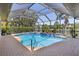Beautiful screened pool enclosure with mature landscaping offering a private oasis at 11447 Savannah Lakes Dr, Parrish, FL 34219
