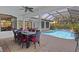 Beautifully landscaped pool area with covered patio, ideal for relaxation and entertainment at 11447 Savannah Lakes Dr, Parrish, FL 34219