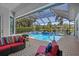 Stunning pool area with screened enclosure, lush landscaping, and serene water views at 11447 Savannah Lakes Dr, Parrish, FL 34219