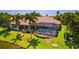 Beautiful backyard with screened in lanai, pool and lush green lawn with mature landscaping at 11447 Savannah Lakes Dr, Parrish, FL 34219