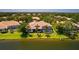 Expansive backyard features a screened pool, lush landscaping, and serene water views from this beautiful home at 11447 Savannah Lakes Dr, Parrish, FL 34219