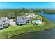 Beautiful aerial view of home with pool, manicured lawn, and waterfront access at 12 Tidy Island Blvd, Bradenton, FL 34210