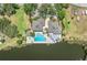 Aerial view of community clubhouse, pool, hot tub, and lake at 12 Tidy Island Blvd, Bradenton, FL 34210