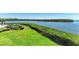 Backyard overlooks the lake with lush landscaping at 12 Tidy Island Blvd, Bradenton, FL 34210