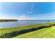 Backyard overlooks the lake with lush landscaping at 12 Tidy Island Blvd, Bradenton, FL 34210