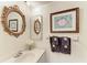Elegant bathroom featuring decorative mirrors, a vanity, and decorative artwork at 12 Tidy Island Blvd, Bradenton, FL 34210