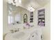 Well-lit bathroom with double vanity and built-in towel storage at 12 Tidy Island Blvd, Bradenton, FL 34210