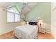 Charming bedroom features a high ceiling, window, and stylish bedside table with lamp at 12 Tidy Island Blvd, Bradenton, FL 34210