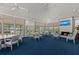 Spacious clubhouse features ample natural light, comfortable seating, fireplace, and large TV at 12 Tidy Island Blvd, Bradenton, FL 34210