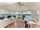 Bright dining area with water views features floor-to-ceiling windows and modern decor at 12 Tidy Island Blvd, Bradenton, FL 34210