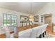 Bright dining room with a long table, chairs, elegant chandelier, and natural light at 12 Tidy Island Blvd, Bradenton, FL 34210