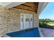 Inviting front entrance with a white front door, decorative brickwork, and well-manicured landscaping at 12 Tidy Island Blvd, Bradenton, FL 34210