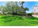 Well-maintained front yard with lush green grass and beautiful landscaping surrounding the home at 12 Tidy Island Blvd, Bradenton, FL 34210