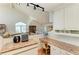 Bright kitchen with granite counters, white cabinets, hardwood floors, and vaulted ceilings at 12 Tidy Island Blvd, Bradenton, FL 34210