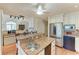 Well-lit kitchen features granite counters, stainless steel appliances, and a ceiling fan at 12 Tidy Island Blvd, Bradenton, FL 34210
