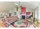 Open-concept living room featuring a fireplace, hardwood floors, and large windows at 12 Tidy Island Blvd, Bradenton, FL 34210