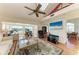 Bright living room with a ceiling fan and large windows offering water views at 12 Tidy Island Blvd, Bradenton, FL 34210