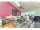 Spacious living room featuring vaulted ceilings with skylights and bright pink walls at 12 Tidy Island Blvd, Bradenton, FL 34210