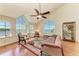 Elegant living room featuring hardwood floors, large windows, and water views at 12 Tidy Island Blvd, Bradenton, FL 34210