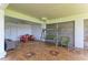 Cozy covered patio featuring a picnic table, swing, and chair for relaxing outdoors at 12 Tidy Island Blvd, Bradenton, FL 34210