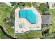 High angle of community pool and hot tub surrounded by tan patio and lounge seating with green landscaping at 12 Tidy Island Blvd, Bradenton, FL 34210