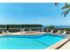 Community pool with hot tub and views of the bay, furnished with lounge chairs and tables at 12 Tidy Island Blvd, Bradenton, FL 34210
