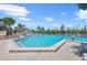 Community pool with lounge seating, tables, and palm trees at 12 Tidy Island Blvd, Bradenton, FL 34210