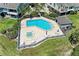 Aerial view of community pool and jacuzzi with surrounding patio and lounge seating and manicured green space at 12 Tidy Island Blvd, Bradenton, FL 34210