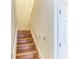 Wooden staircase with white railing near a closed door at 12 Tidy Island Blvd, Bradenton, FL 34210