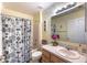 Well-lit bathroom features a shower-tub combo, a white sink, and modern decor at 12026 Warwick Cir, Parrish, FL 34219