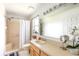 Bathroom features a shower-tub combo, a large mirror, and a wooden vanity at 12026 Warwick Cir, Parrish, FL 34219