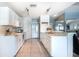 Well-appointed kitchen with white cabinetry, marble countertops, stainless steel appliances, and tiled floors at 12026 Warwick Cir, Parrish, FL 34219