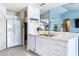Clean, white kitchen with stainless steel appliances, marble countertops, and an open design to the living areas at 12026 Warwick Cir, Parrish, FL 34219
