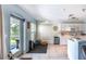 Well-lit kitchen with white cabinets, tile floors, stainless steel appliances, and an adjacent exercise area at 12026 Warwick Cir, Parrish, FL 34219