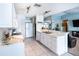 Open kitchen featuring white cabinets, marble countertops, stainless steel appliances, and views of the living room at 12026 Warwick Cir, Parrish, FL 34219