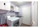 Clean laundry room features white cabinets, washer, dryer, and room for organization and storage at 12026 Warwick Cir, Parrish, FL 34219