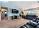 Comfortable living room with entertainment center, leather furniture, and neutral carpet at 12026 Warwick Cir, Parrish, FL 34219