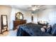 A well-lit main bedroom offers space, a ceiling fan, and a decorative mirror at 12026 Warwick Cir, Parrish, FL 34219