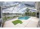 Enclosed pool and lanai area with putting green overlooking lake provides an outdoor recreational space at 12026 Warwick Cir, Parrish, FL 34219